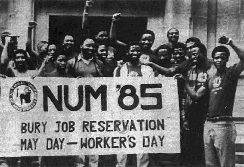 Miners raising fists, holding banner: NUM (National Union of Mineworkers) '85: Bury job reservation: May Day: Workers' day